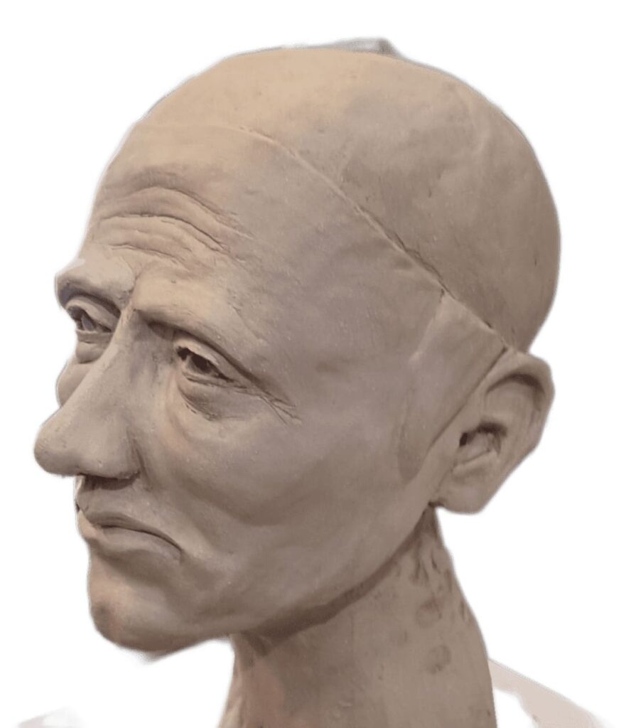 Portrait sculpté en argile montrant un homme de profil, œuvre de Bruno Cotton.
